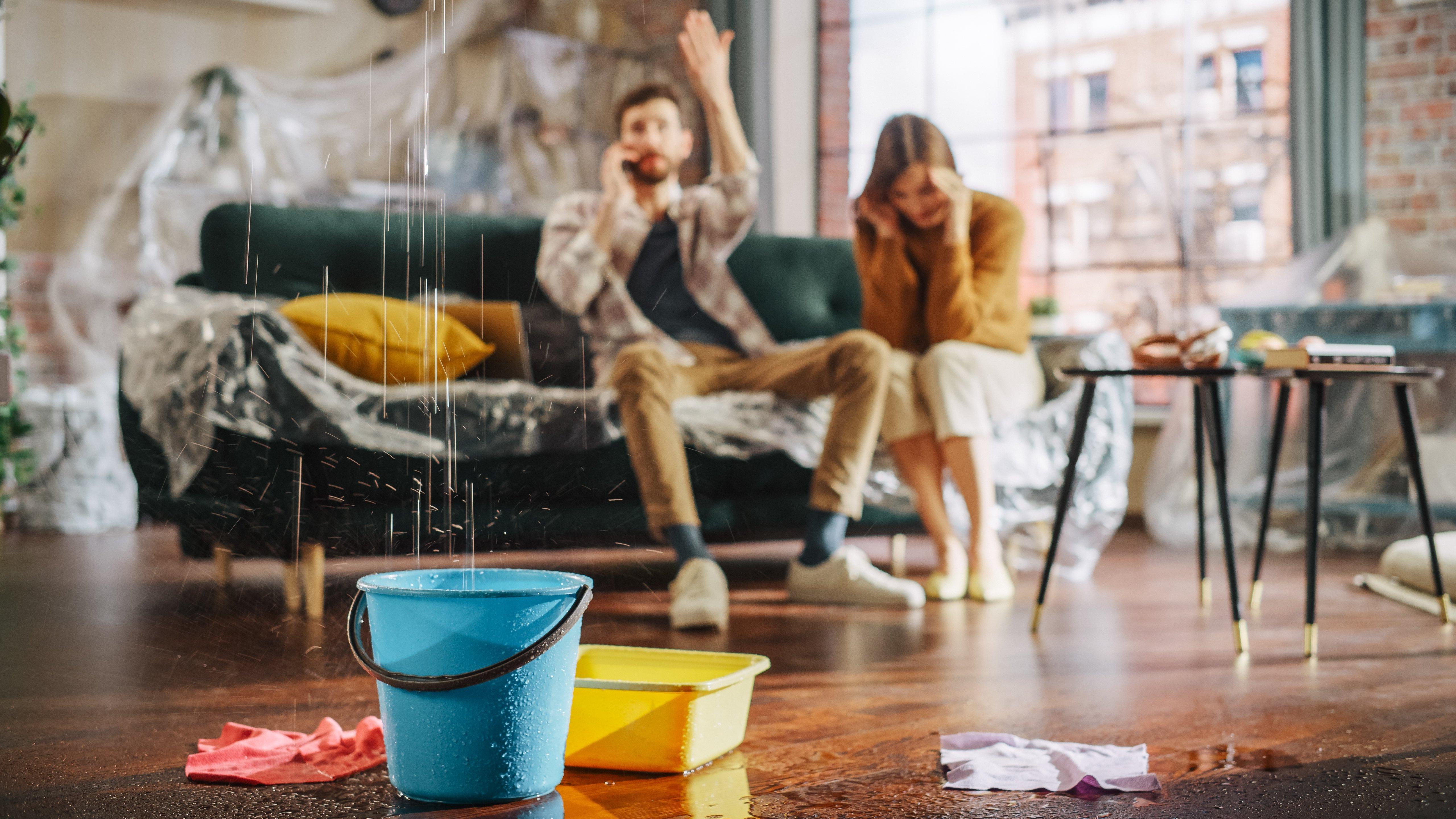 Homeowners react to a roof leaking in their new home 